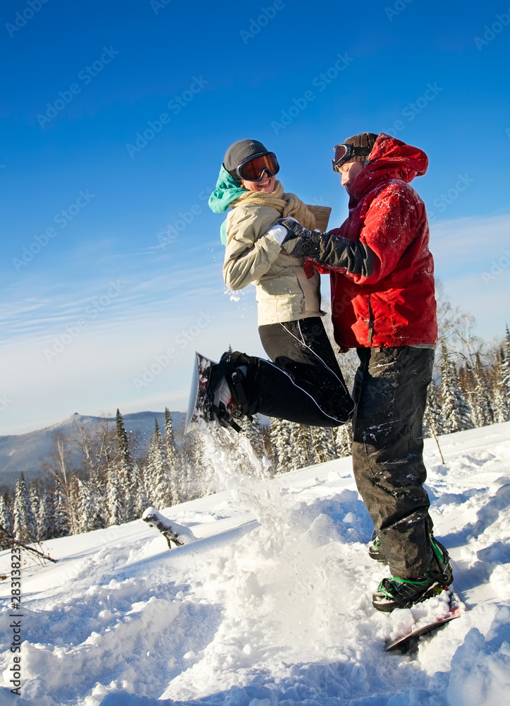 Snowboarders jumping, deep blue sky in background Snowboarders jumping, deep blue sky in background