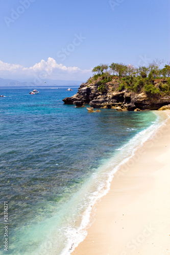 Sandy ocean coast and rocks. Bali. Indonesia