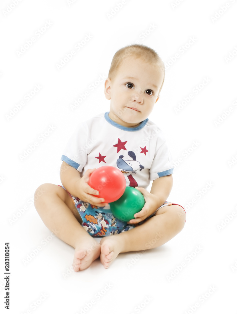 Cute little boy is playing with colorful balls Cute little boy is playing with colorful balls
