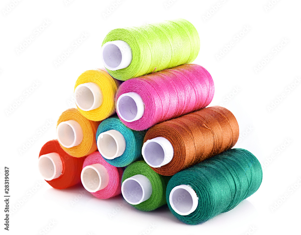 Pyramid of many-coloured bobbins of thread isolated on white Pyramid of many-coloured bobbins of thread isolated on white