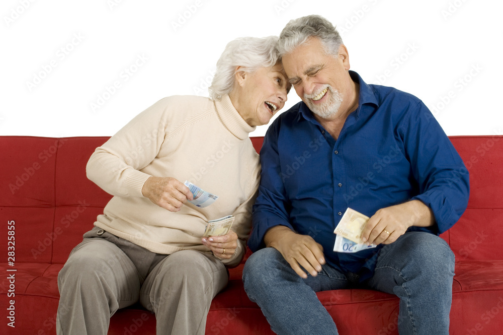 elderly couple on the couch with money in hand