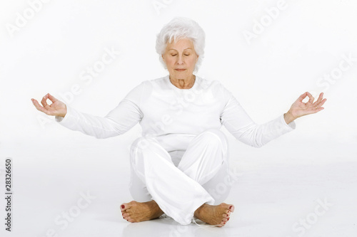 elderly woman practicing yoga