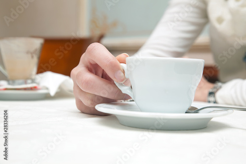 Woman with a cup of coffee in the hands