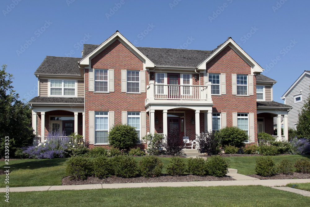 Brick home with front balcony Brick home with front balcony