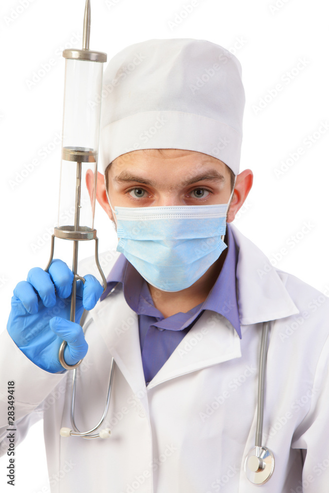 Portrait of the doctor in a mask with the big syringe isolated o Portrait of the doctor in a mask with the big syringe isolated o