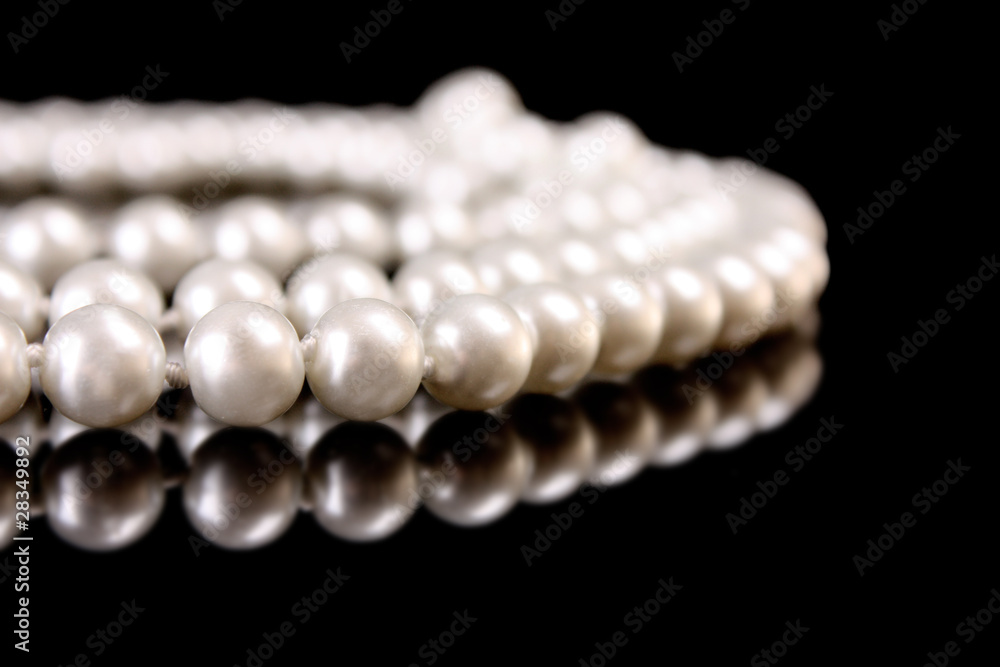 White pearls on black background White pearls on black background