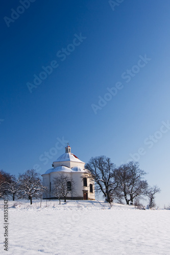 Village chapel in winter countryside