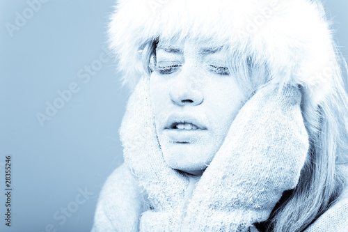 Frozen. Chilled female face covered in ice.