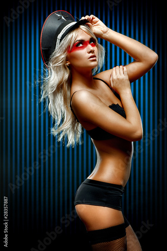 Young sexy woman in front of wall of blue stripes