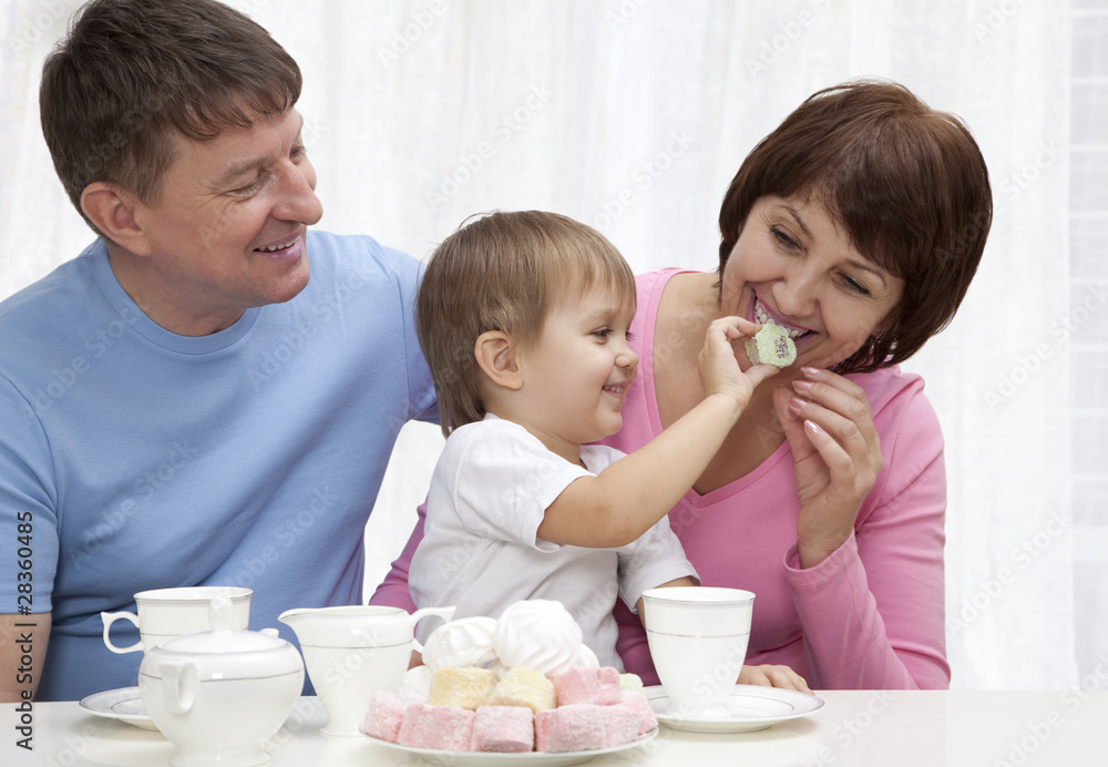Mature couple with grandchild have a breakfast Mature couple with grandchild have a breakfast