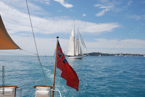 Classic wood sailing Yacht race with red ensign flag