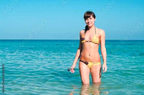 Young sexy girl in blue sea