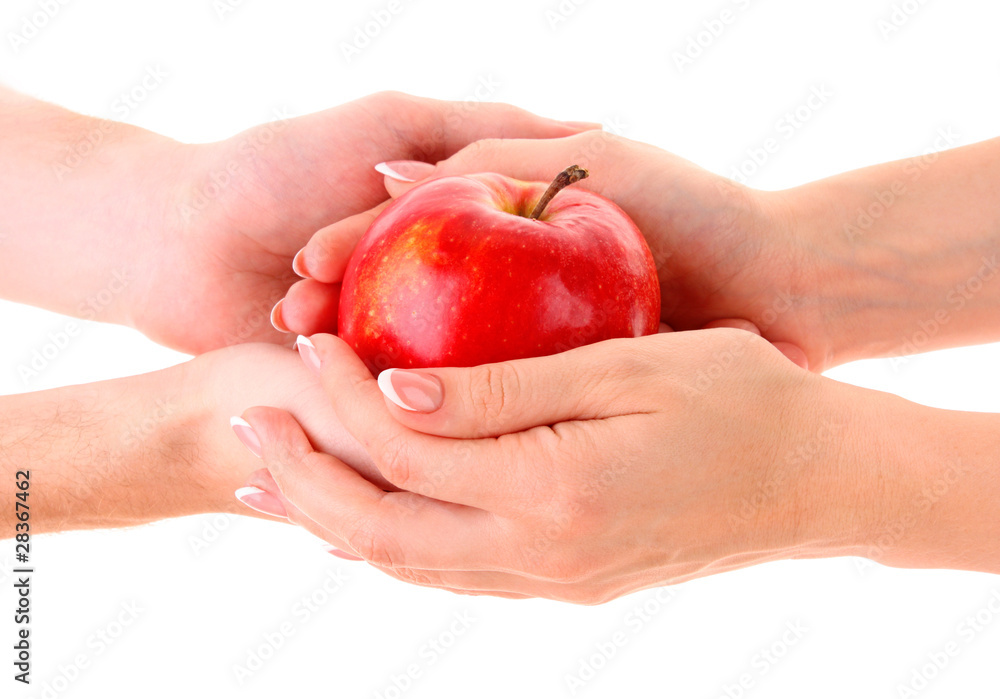 Apple between man and woman hand on white background Apple between man and woman hand on white background