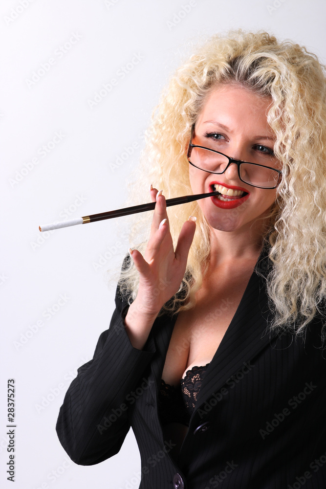 Obraz premium Pretty woman with a mouthpiece. Curly blonde on the grey