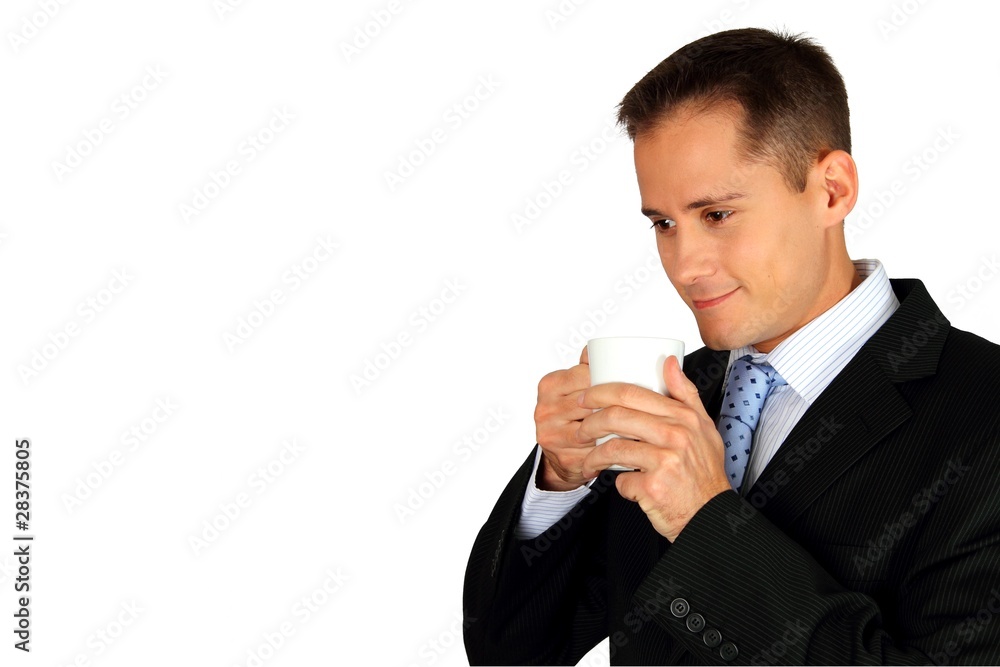 Handsome young business man enjoying the aroma from a cup Handsome young business man enjoying the aroma from a cup