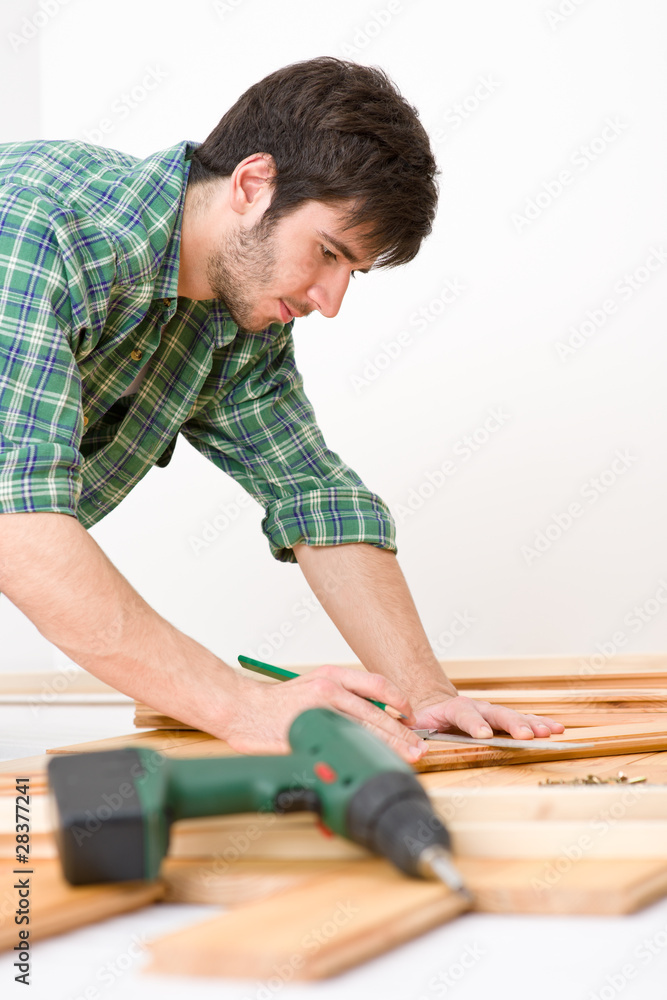 Home improvement - handyman installing wooden floor Home improvement - handyman installing wooden floor