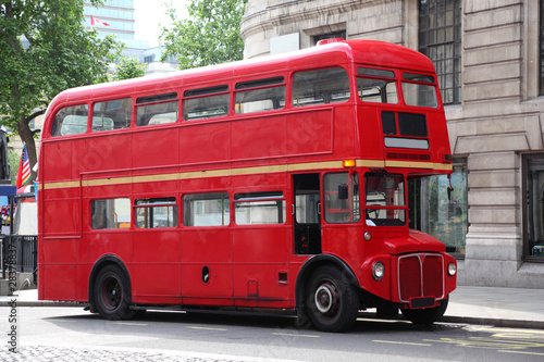 Empty red double-decker on street in London, England.