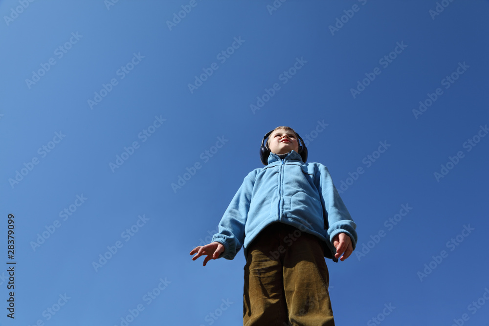 little boy in jacket and big black headphones listens to music little boy in jacket and big black headphones listens to music