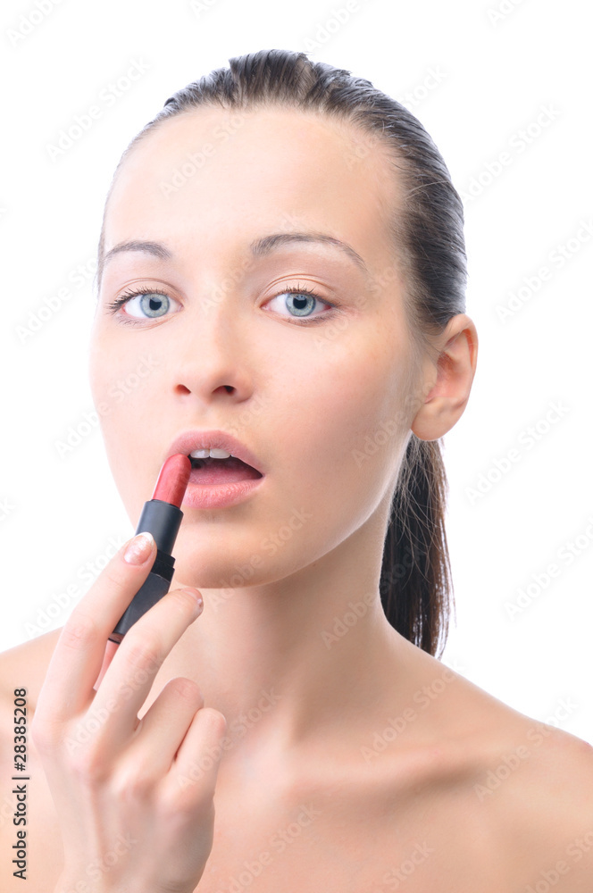 young attractive sensual woman is applying cosmetics on her face young attractive sensual woman is applying cosmetics on her face
