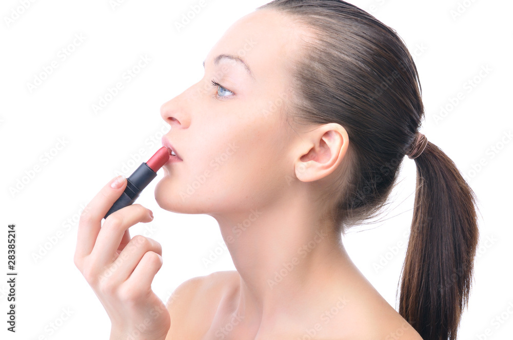 young attractive sensual woman is applying cosmetics on her face young attractive sensual woman is applying cosmetics on her face