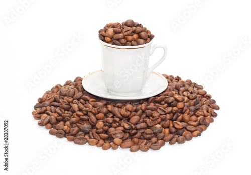 Cup with the corns of coffees on the small group of coffee