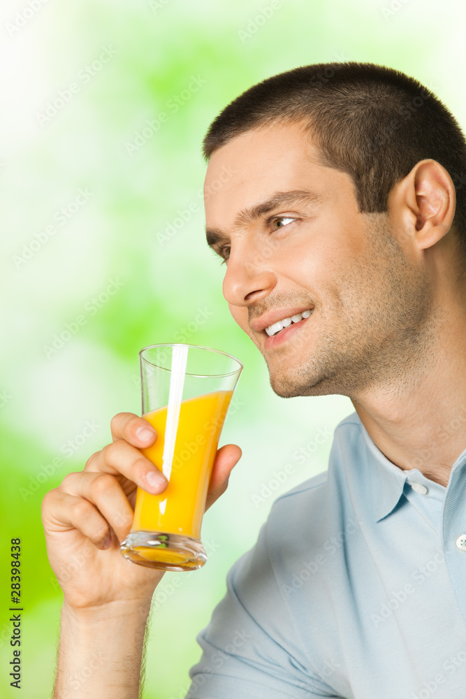 Portrait of smiling man drinking orange juice, outdoor Portrait of smiling man drinking orange juice, outdoor