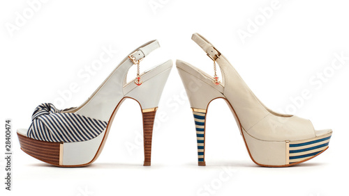 Two female open-toe shoes on the white background