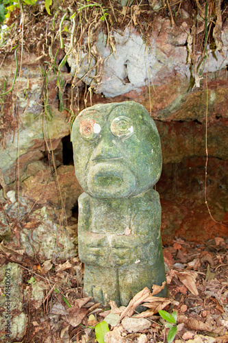 Canvas Print Ancient culpture of Taino Indian in front of cave in Baracoa