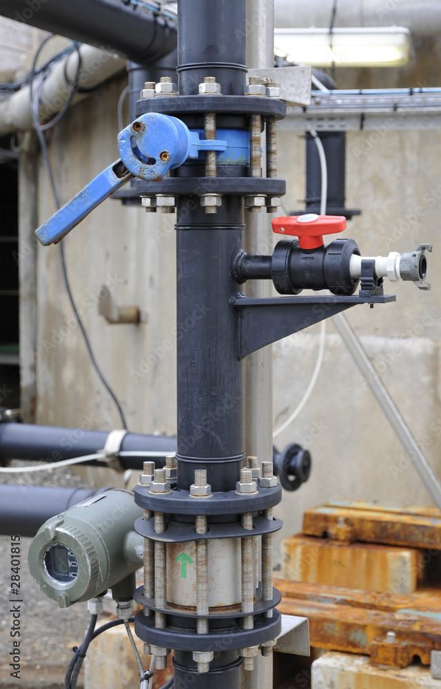 Industrial black plastic tube with some floodgates and pumps Industrial black plastic tube with some floodgates and pumps