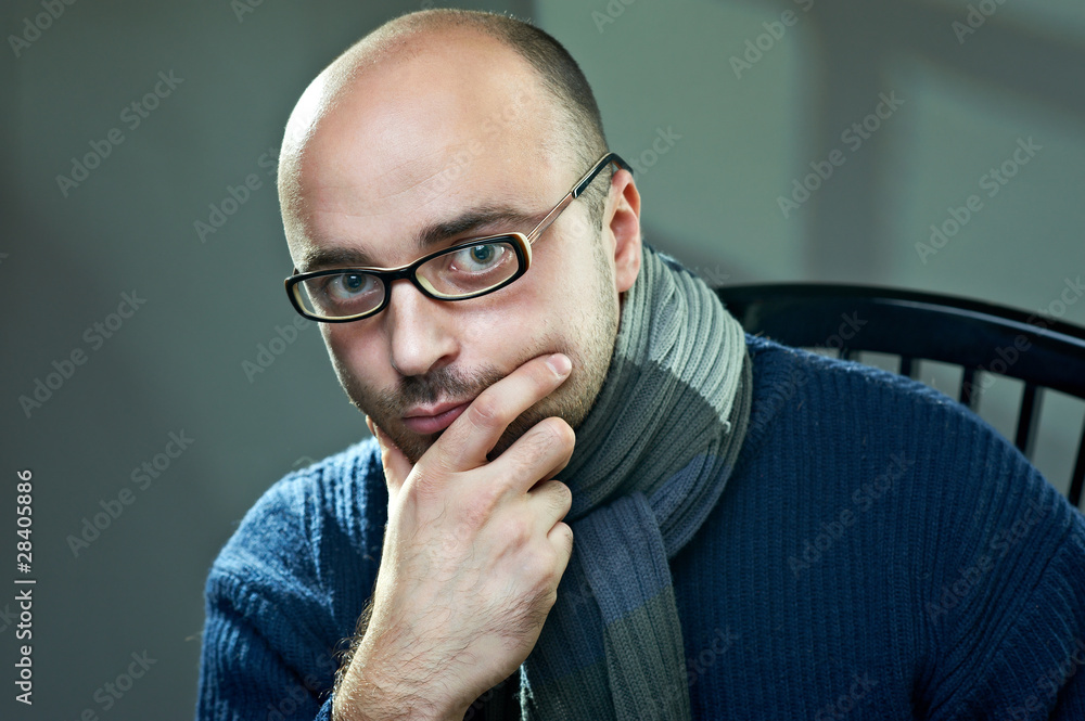 Portrait of a bald serious man in glasses Portrait of a bald serious man in glasses