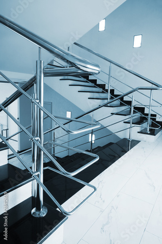 Tela staircase with a steel handrail