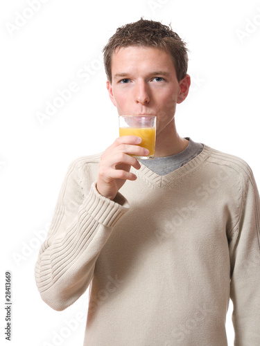young man drinking orange juice isolated on white background