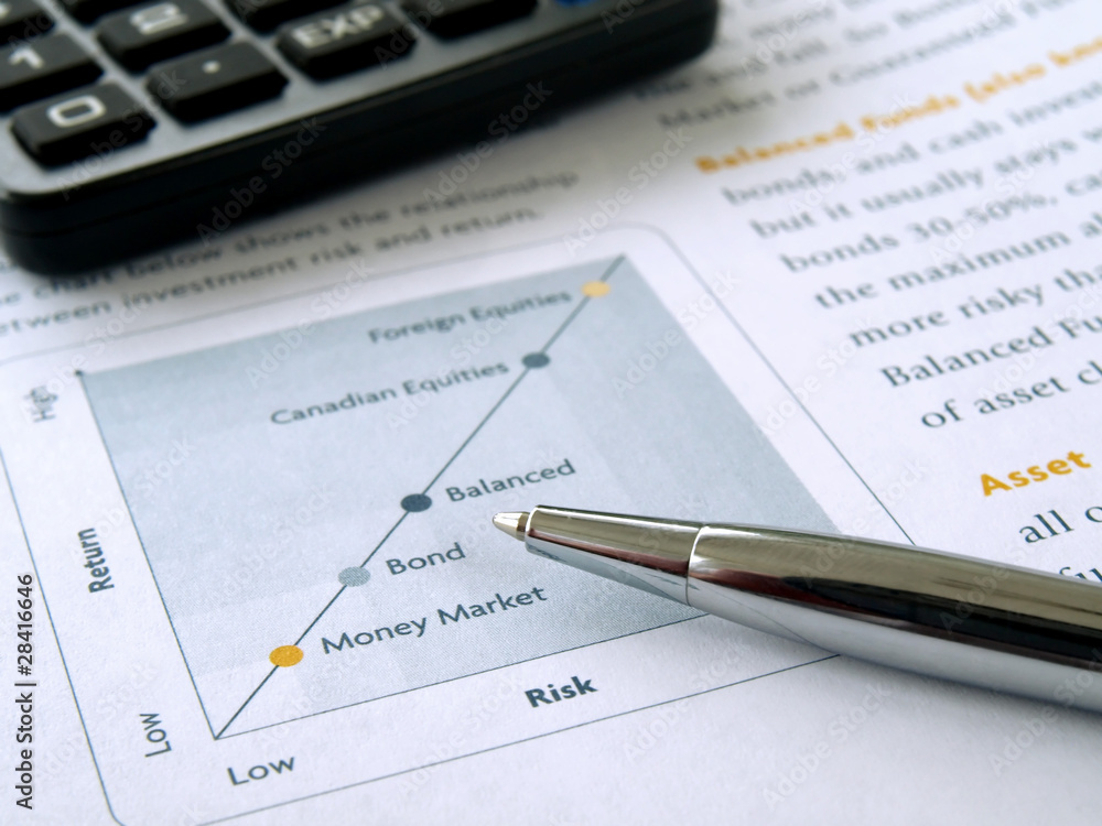 Pen on the investment chart with calculator Pen on the investment chart with calculator