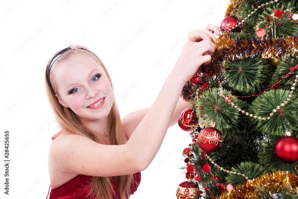 Beautiful girl decorating a Christmas tree