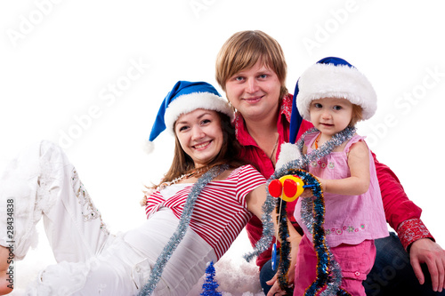 Family in Santa's hat sitting in artificial snow