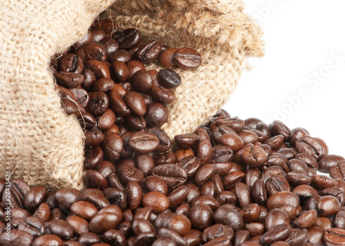 Coffee beans in canvas sack on white background
