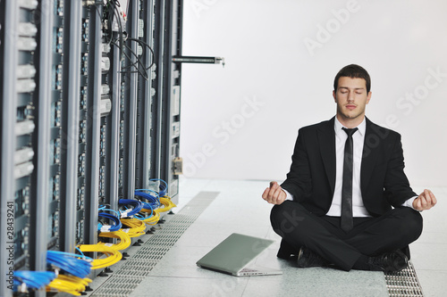 business man practice yoga at network server room photo