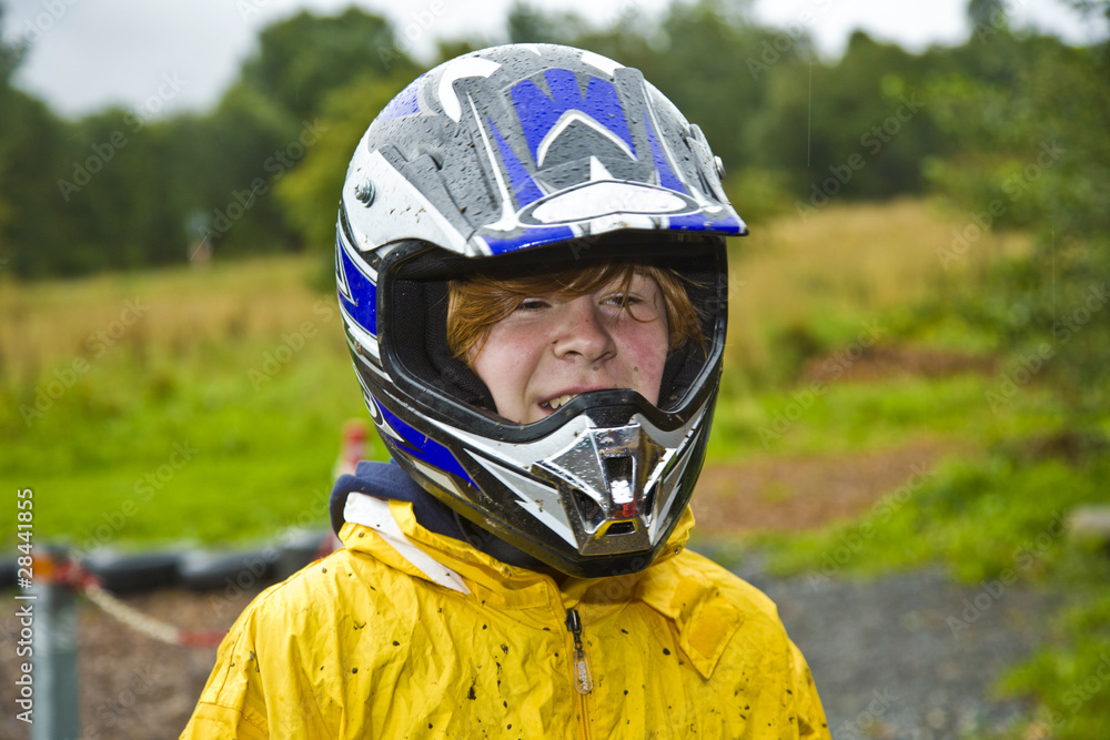happy boy with helmet at the kart trail happy boy with helmet at the kart trail