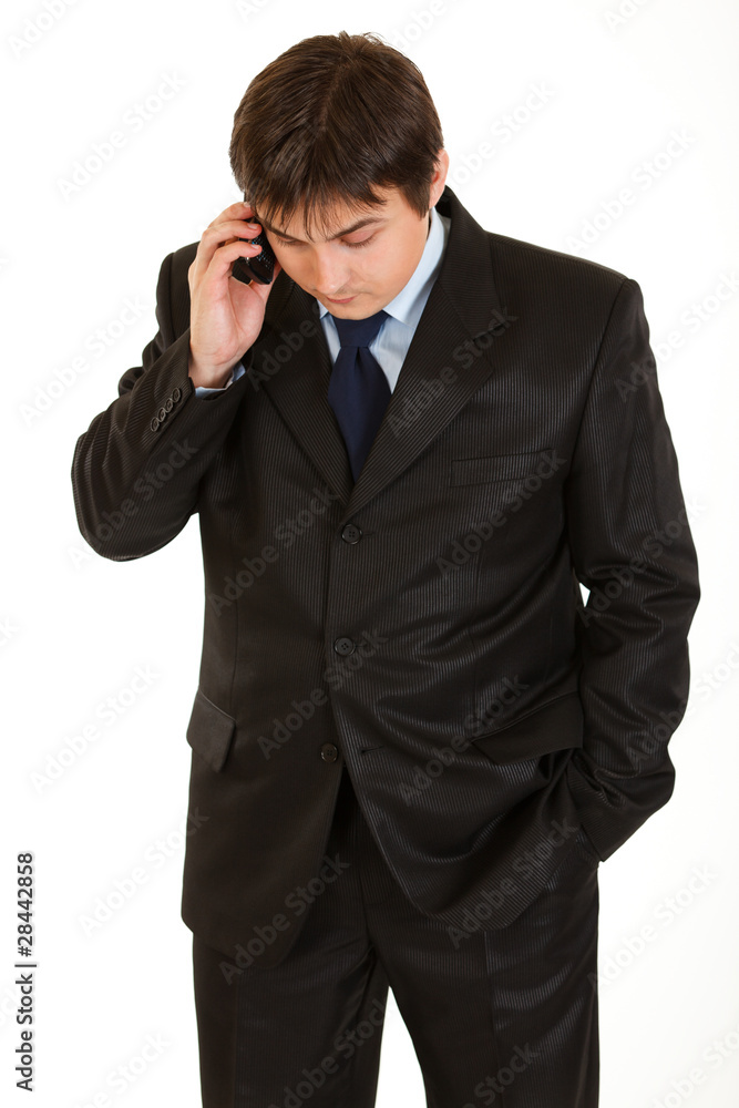 Modern businessman talking on mobile phone isolated on white. Modern businessman talking on mobile phone isolated on white.