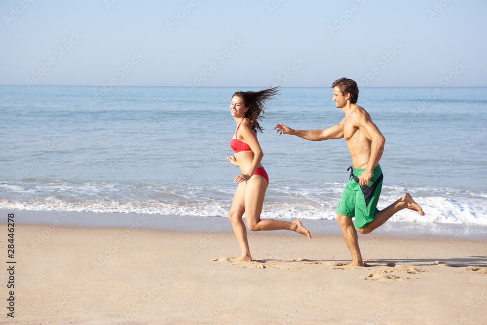 Young couple running on beach