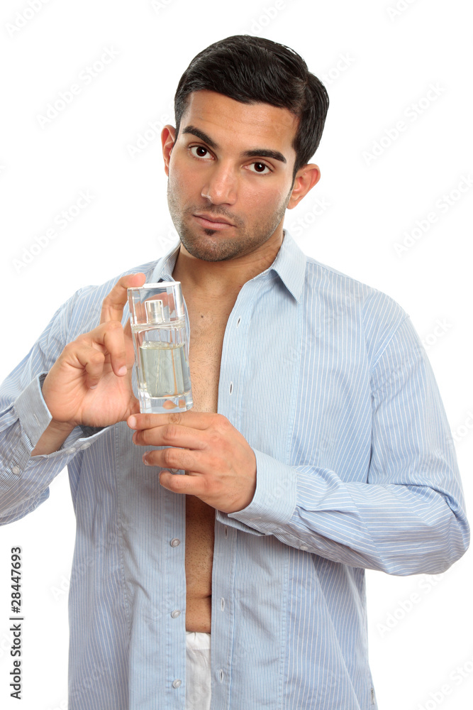 Handsome man showing perfume cologne fragrance Handsome man showing perfume cologne fragrance