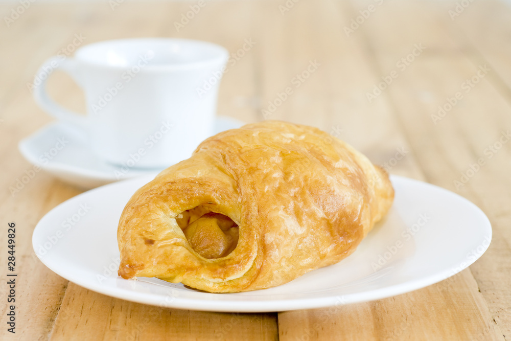 A cup of black coffee with Plate of sausage rolls