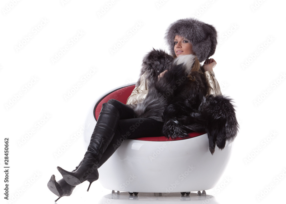 Young woman in fur sit on armchair Young woman in fur sit on armchair