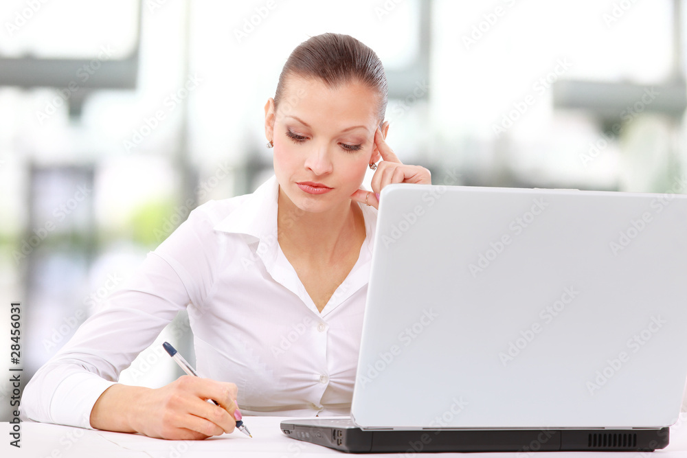 an adorable business woman working at her desk an adorable business woman working at her desk