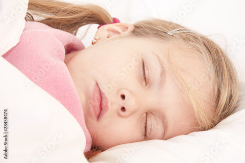 Sleeping little girl on bed