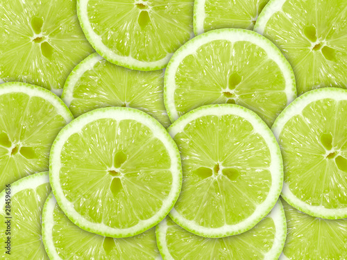 Abstract green background with citrus-fruit of lime slices