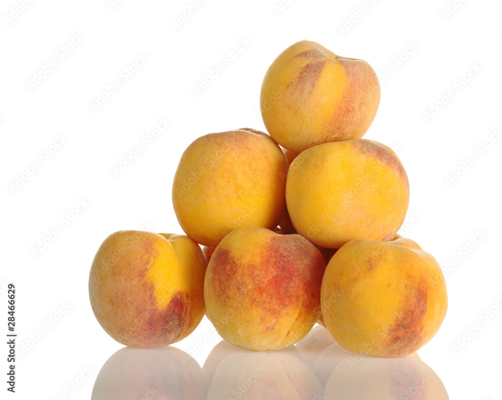 A pile of yellow-red colored peaches on white A pile of yellow-red colored peaches on white