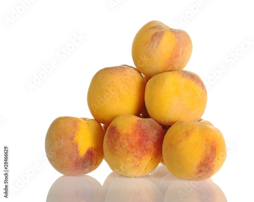 A pile of yellow-red colored peaches on white