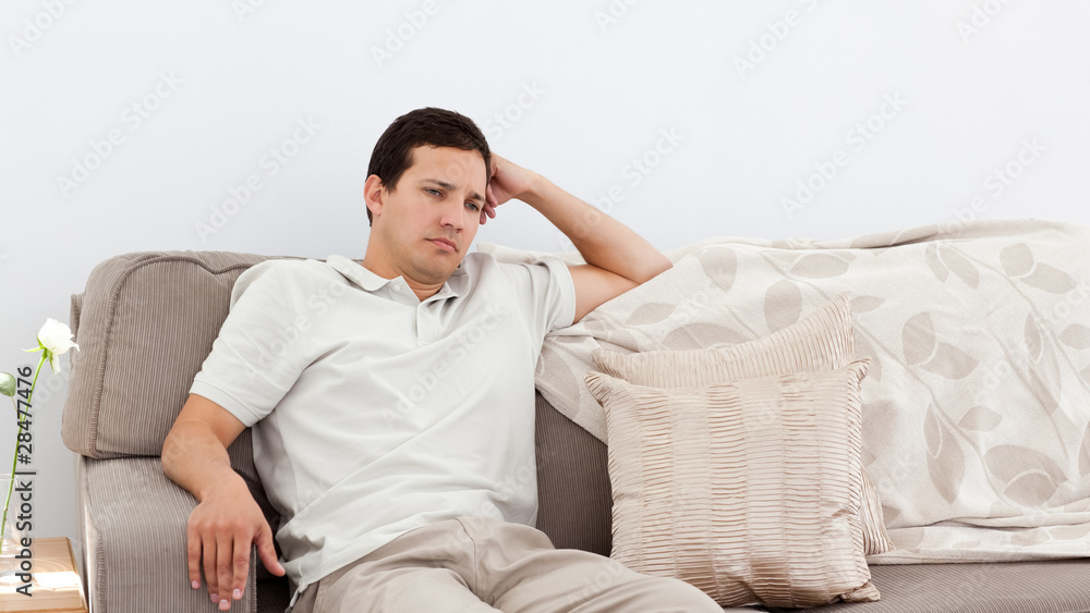 Depressed man thinking on the sofa