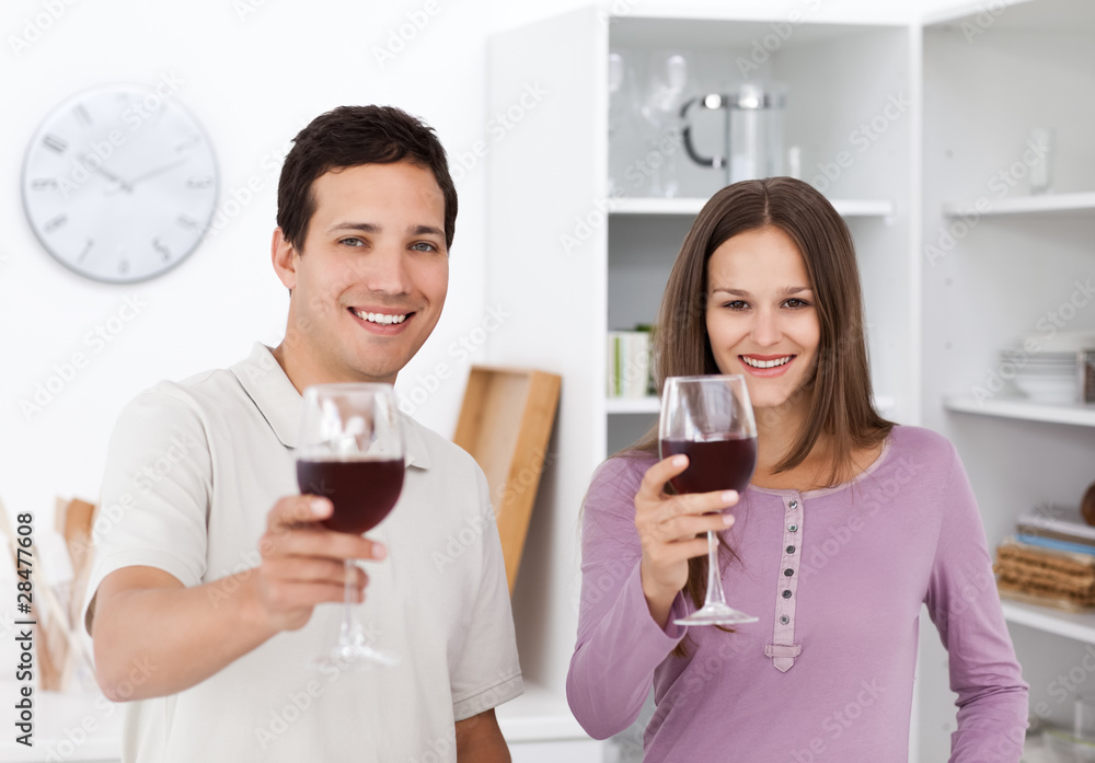 Young couple toasting with glasses of red wine Young couple toasting with glasses of red wine